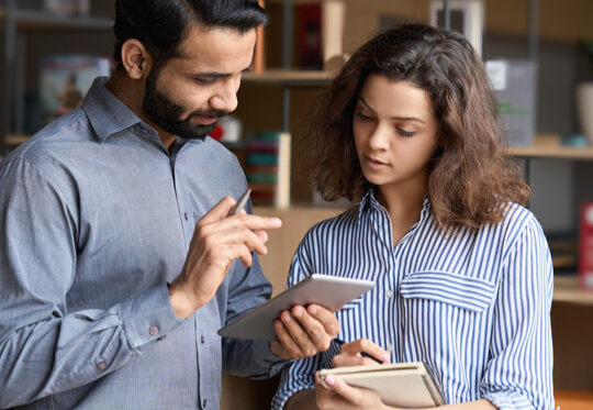 Two professionals reviewing notes together